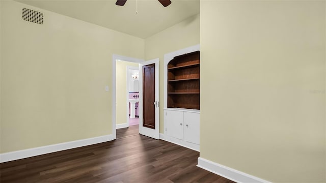 unfurnished room featuring dark hardwood / wood-style floors, ceiling fan, and sink