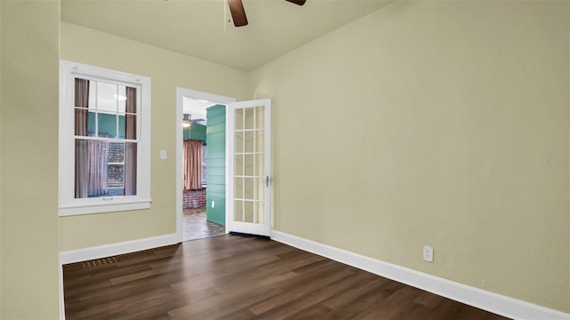 spare room with dark hardwood / wood-style flooring and french doors