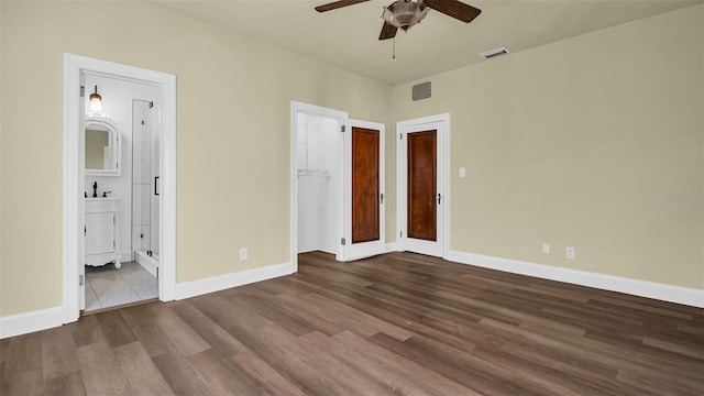 unfurnished bedroom with hardwood / wood-style flooring, ensuite bath, and ceiling fan