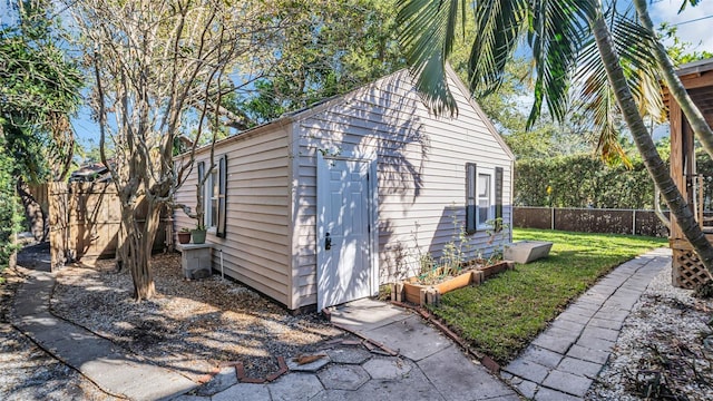 view of outbuilding with a yard