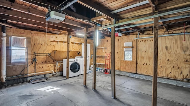 basement with separate washer and dryer and wooden walls