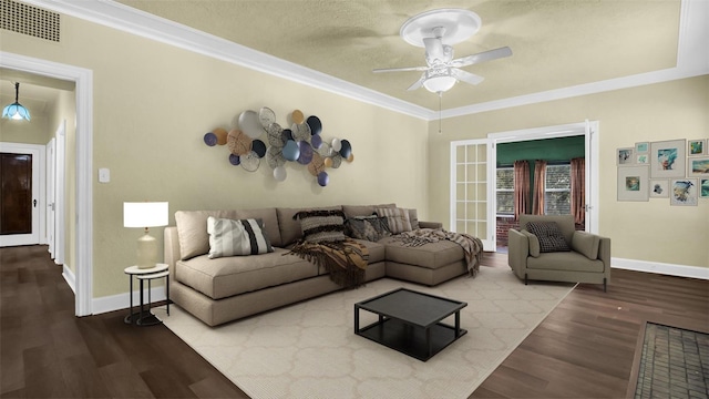 living room with a textured ceiling, hardwood / wood-style flooring, ceiling fan, and ornamental molding