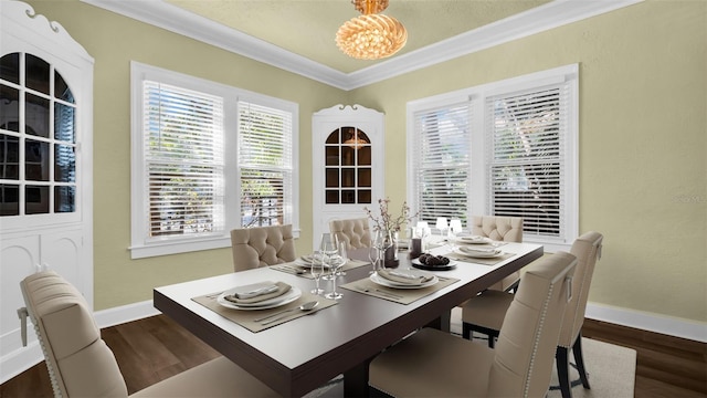 dining space featuring a notable chandelier, dark hardwood / wood-style floors, and ornamental molding