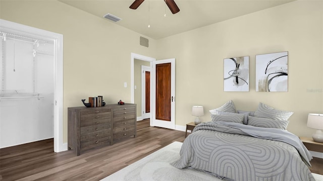 bedroom with ceiling fan and dark wood-type flooring