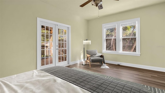 bedroom with hardwood / wood-style floors, multiple windows, and ceiling fan