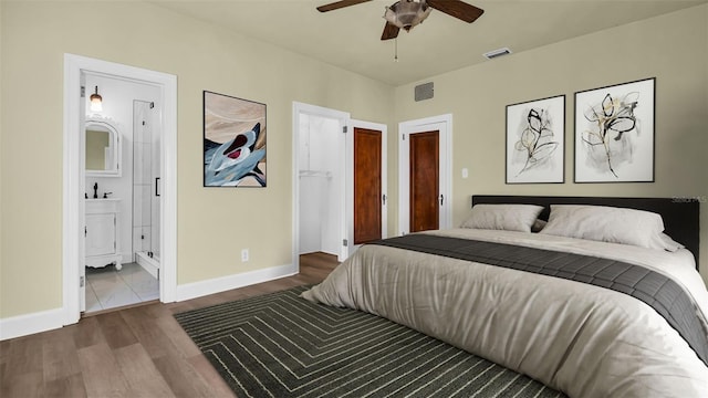 bedroom featuring ensuite bath, ceiling fan, and wood-type flooring