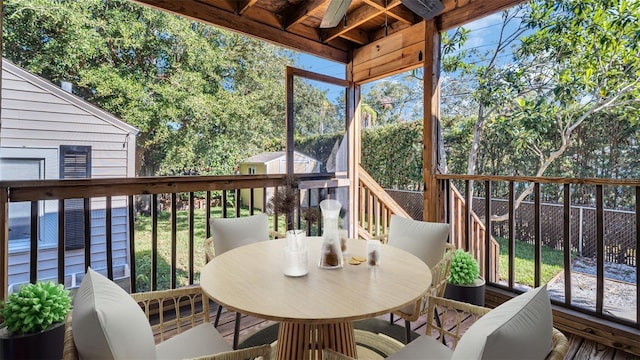 exterior space featuring ceiling fan and a shed