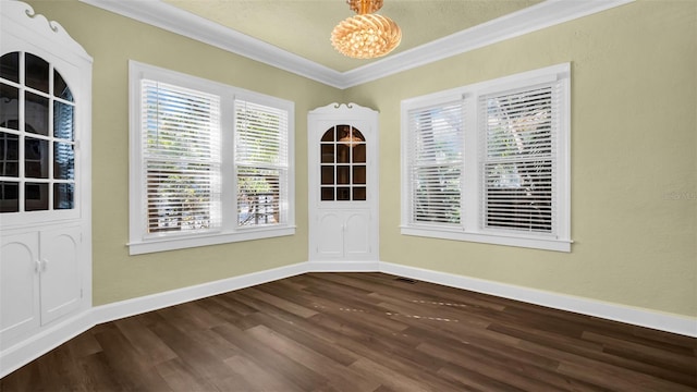 unfurnished dining area with wood-type flooring, a notable chandelier, and ornamental molding