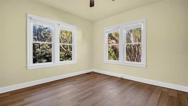 spare room with ceiling fan and wood-type flooring