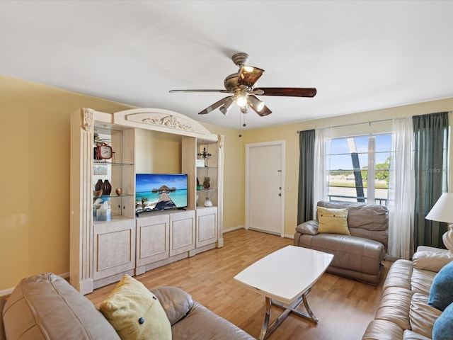 living room with ceiling fan and light hardwood / wood-style flooring