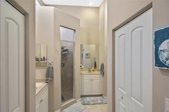 bathroom with tile patterned flooring, vanity, and a shower with shower door