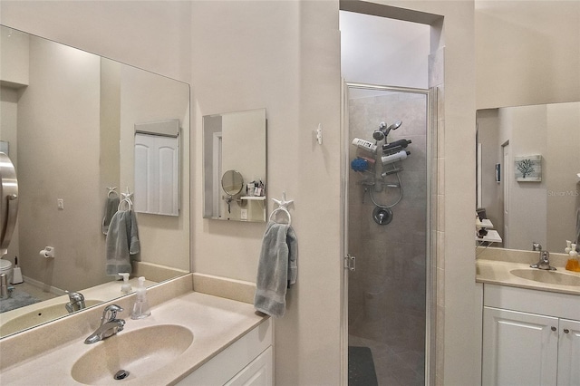 bathroom with vanity, toilet, and a shower with shower door