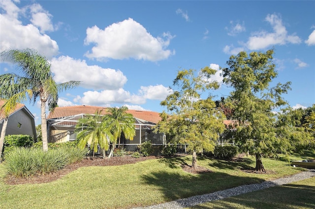 view of front of property with a front lawn and a lanai