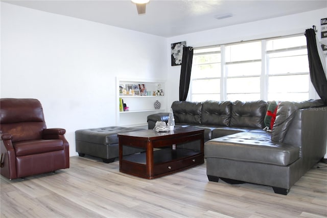 living room with ceiling fan and light wood-type flooring