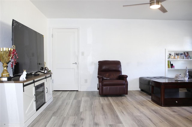 living area with ceiling fan and light hardwood / wood-style flooring