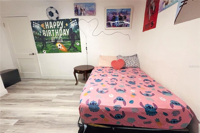 bedroom with wood-type flooring