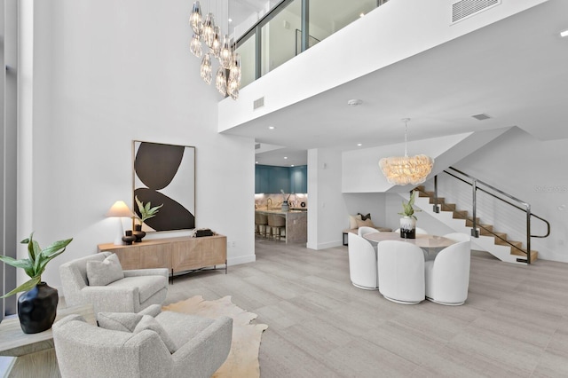 living room featuring light hardwood / wood-style floors and a chandelier