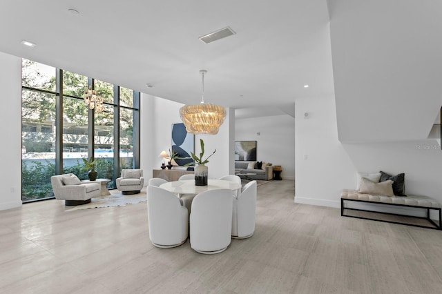 dining room with a notable chandelier and expansive windows