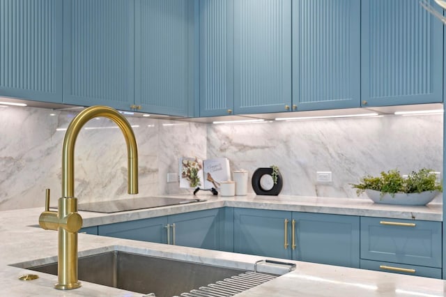 interior space featuring blue cabinetry and tasteful backsplash