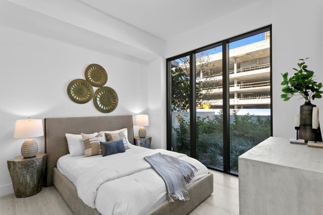 bedroom featuring access to outside and light hardwood / wood-style flooring