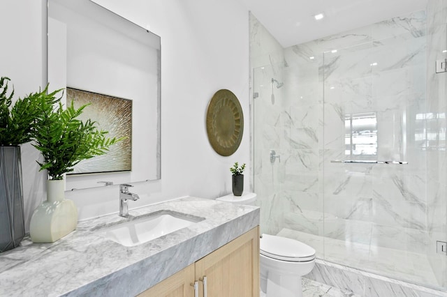 bathroom with vanity, toilet, and a shower with shower door