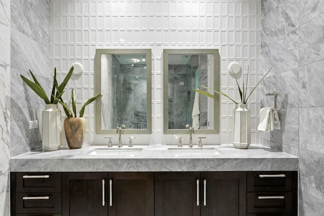 bathroom with vanity, tile walls, and walk in shower