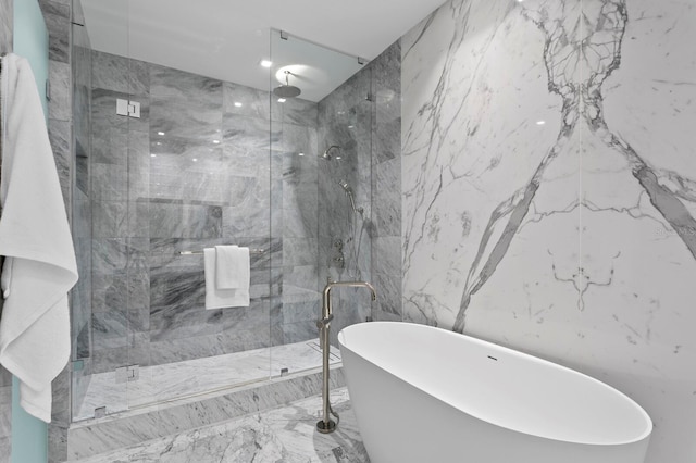 bathroom featuring shower with separate bathtub