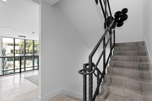 stairs with floor to ceiling windows