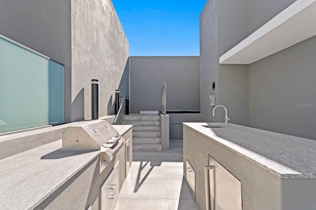 view of patio / terrace featuring area for grilling, sink, and an outdoor kitchen