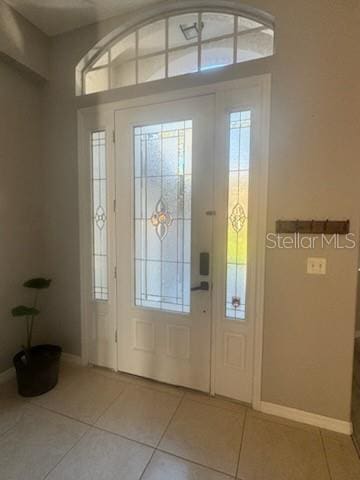 foyer entrance with light tile patterned floors