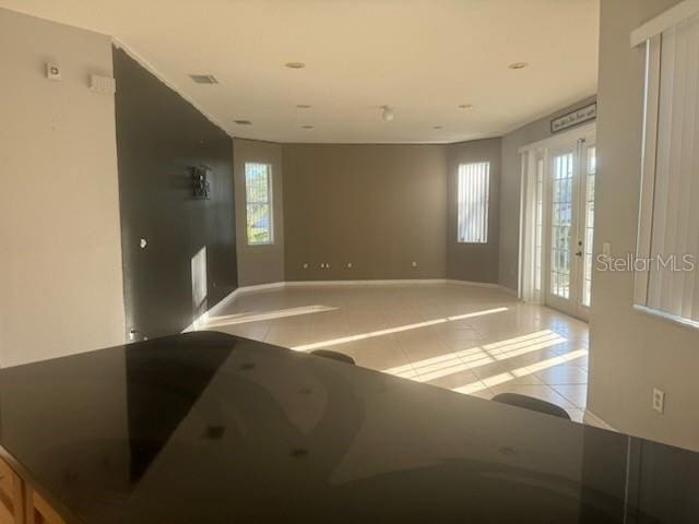 tiled empty room with french doors