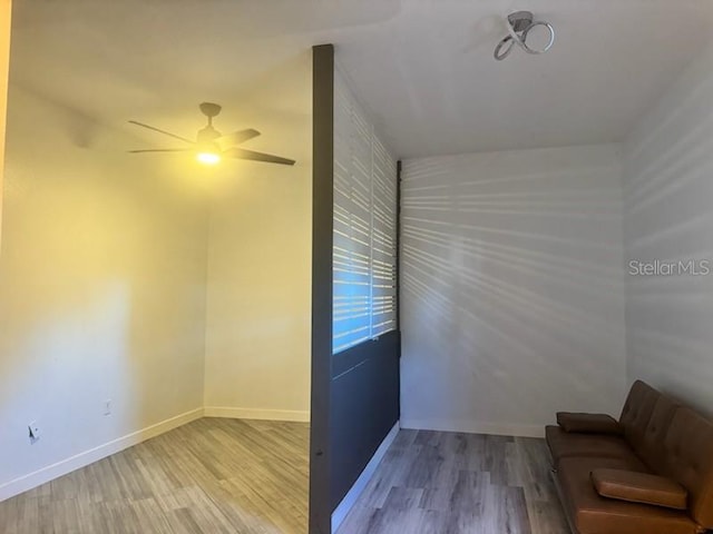 unfurnished room with light wood-type flooring and ceiling fan