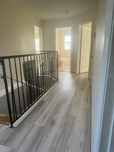 4015 Woodacre Ln, Tampa, FL 33624 - hall featuring an upstairs landing, wood finished floors, and baseboards