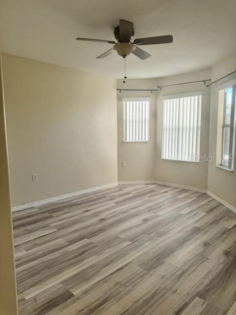 empty room featuring light hardwood / wood-style floors and ceiling fan