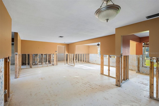 unfurnished room with visible vents and a ceiling fan