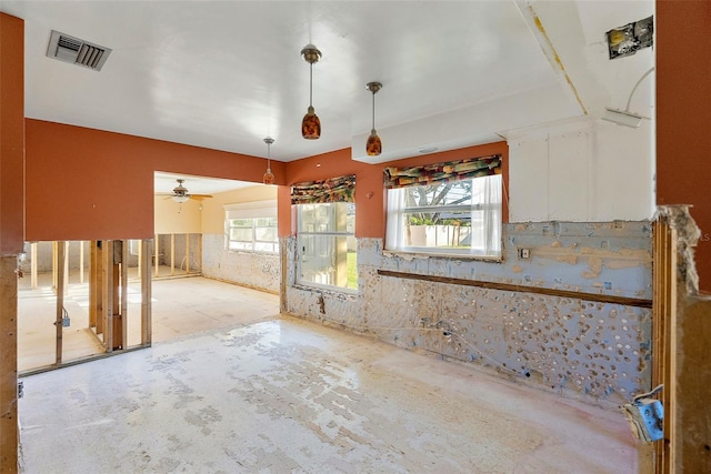 spare room featuring a wainscoted wall and visible vents