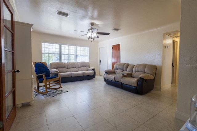 tiled living room with ceiling fan