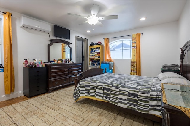 bedroom featuring light wood-type flooring, an AC wall unit, and ceiling fan