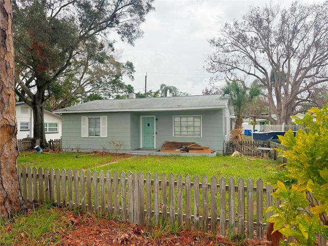 ranch-style home with a front lawn