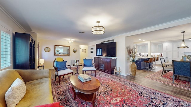 living room with hardwood / wood-style flooring and ornamental molding