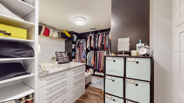 walk in closet featuring dark wood-type flooring