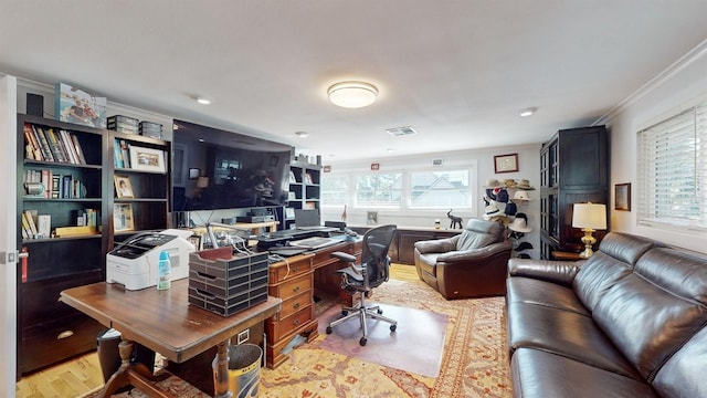 office with light hardwood / wood-style flooring, a wealth of natural light, and ornamental molding