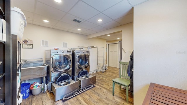 washroom with wood-type flooring and separate washer and dryer