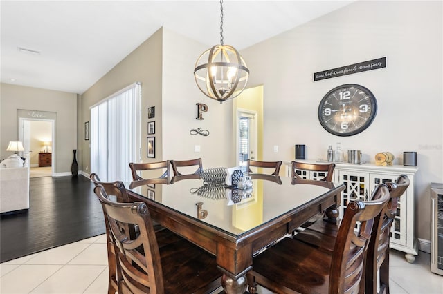 dining room featuring a notable chandelier and light tile patterned flooring