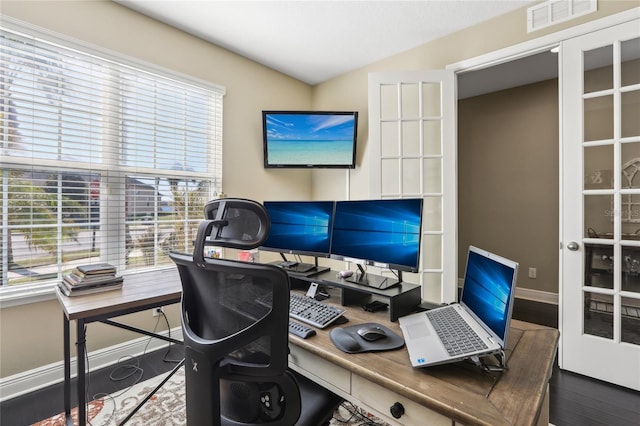 office area featuring vaulted ceiling, dark wood-type flooring, and french doors