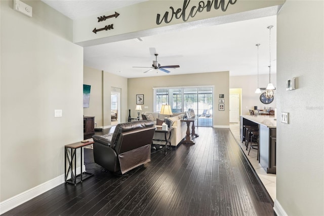 living room featuring ceiling fan and hardwood / wood-style flooring