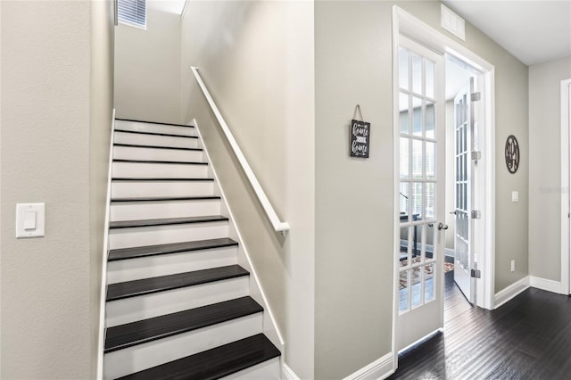 staircase with french doors and hardwood / wood-style flooring