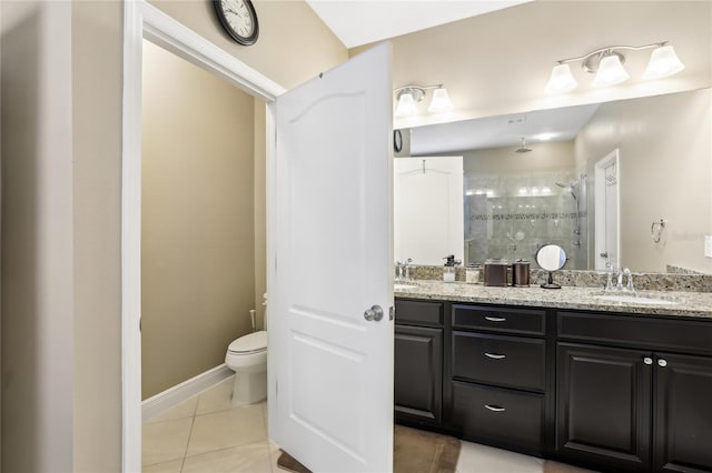 bathroom featuring vanity, toilet, tile patterned flooring, and an enclosed shower