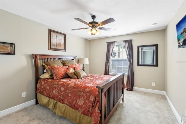 bedroom with ceiling fan and light colored carpet