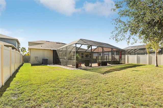 back of house with a lanai, central AC, a lawn, and a patio